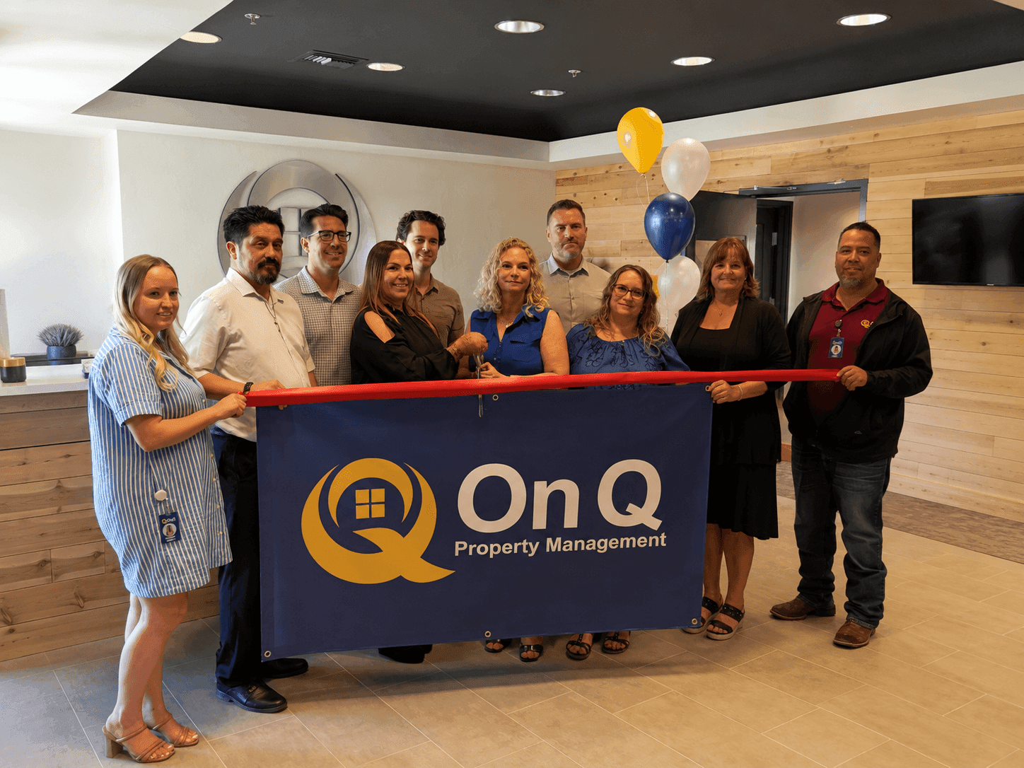 On Q Property Management Tucson office ribbon cutting with the Tucson Chamber of Commerce